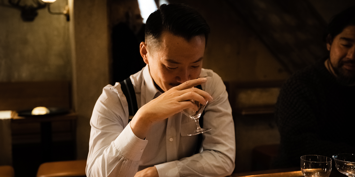 A guest experiencing the aroma of a drink in a SIP AND GUZZLE glass