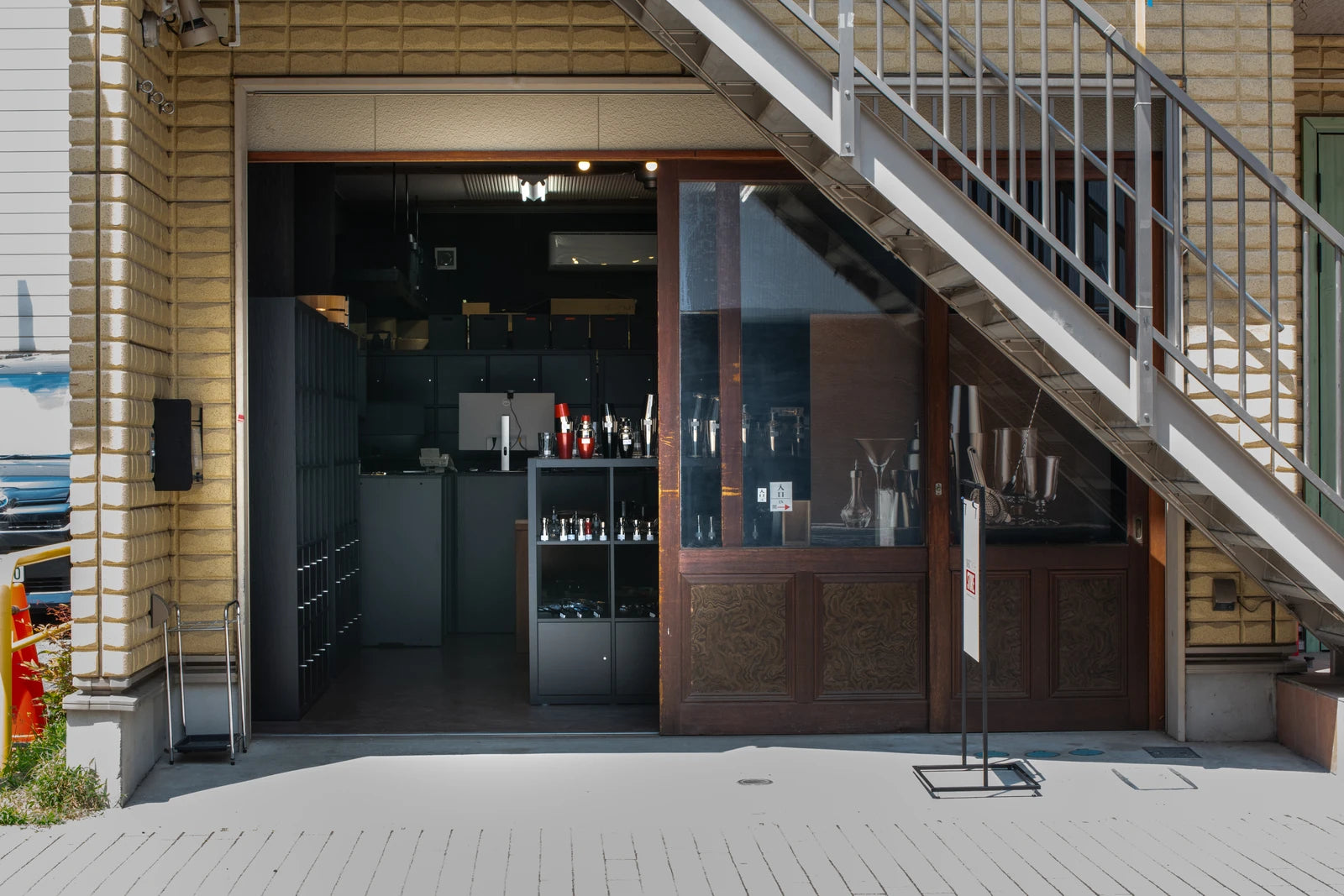 Entrance to BAR TIMES STORE Asakusa on the ground floor, beneath the outdoor staircase