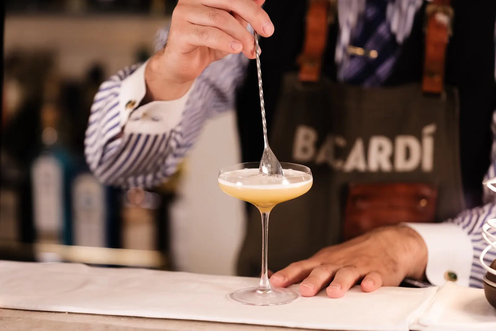 Placing a bar spoon at the surface of a cocktail at 3rd.AVE BAR