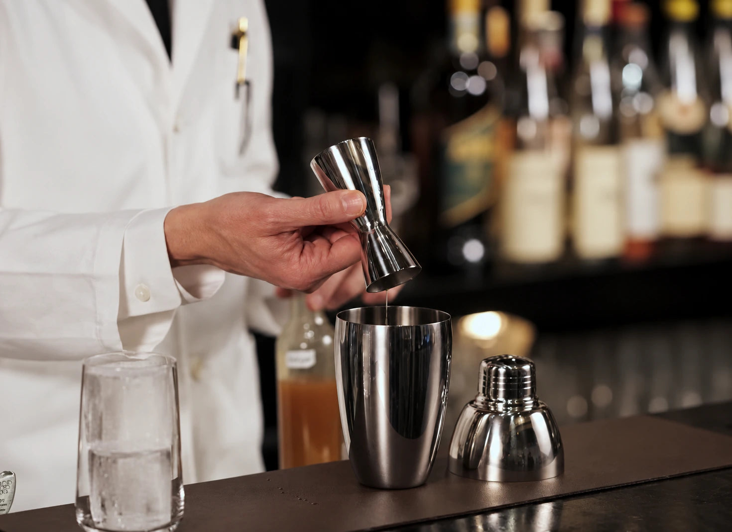 Pouring from a jigger into a shaker